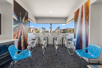 A room with a firework mural on the wall and bicycles parked in front of it.